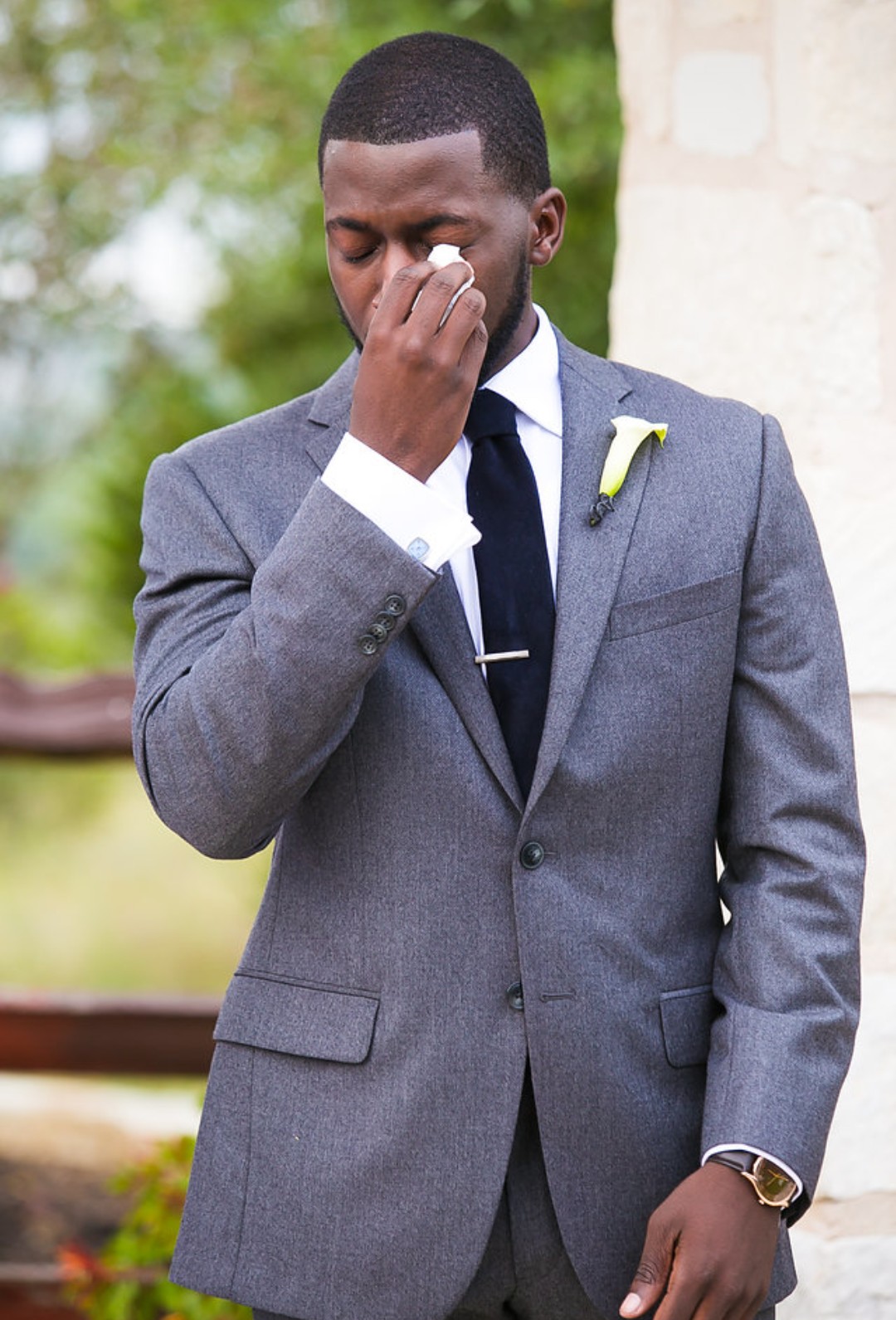 Photo showing Harris wiping his eyes with a tissue during the wedding ceremony.