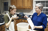 Morgan cooking with a woman in a kitchen