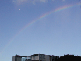 A rainbow over a building