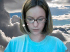 A woman with clouds in the background