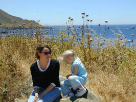 Mother and daughter near water