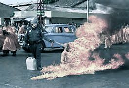 Figure 12 Monk immolation with the pepper-spraying cop. In the original photo, a monk is burning, barely visible through flames. In the meme, the monk is also pepper sprayed from behind.