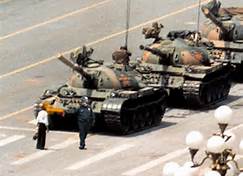 Figure 10 The pepper spraying cop is portrayed with the Tank Man of Tiananmen Square. The original image includes three tanks headed toward a man blocking their way. In the meme, the pepper spraying cop accosts the Tank Man.