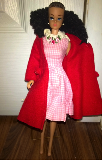 A doll wearing a red coat