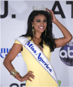 An Indian woman wearing a Miss America sash