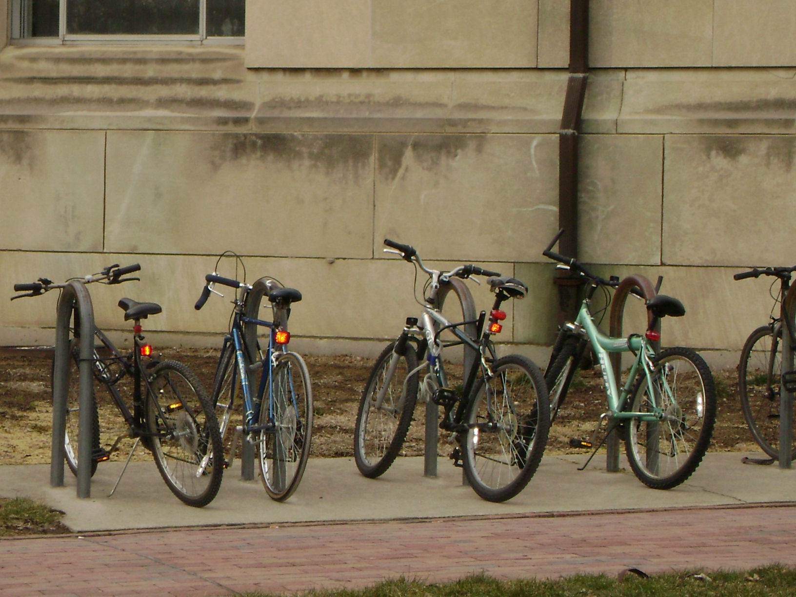 photo of a row of bicycles parked in front of a building