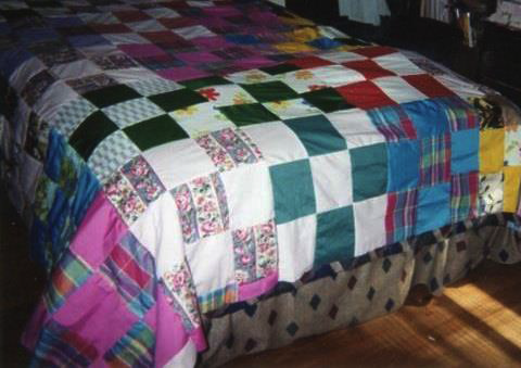 Lillie’s sister’s Block-style quilt. Quilt uses single fabric square blocks, alternating in bright/dark or light/dark pattern.