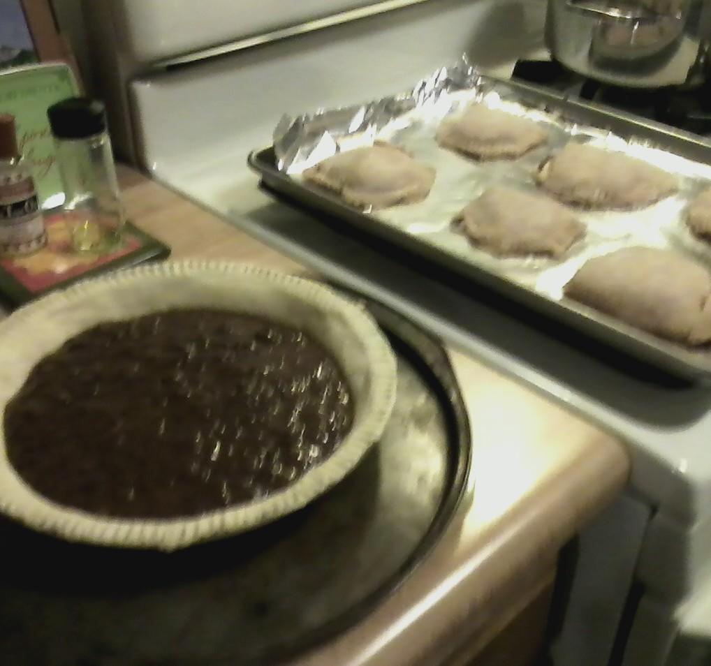 Lillie’s version of MJ’s prune puffs. Image includes unbaked open-face prune pie left) and a foil-lined baking sheet with 6 large prune puffs (right) sitting on top of a counter and stovetop.