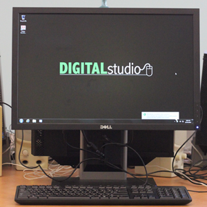 A computer monitor has a keyboard and mouse in front of it. The monitor's screen says "DIGITAL studio."