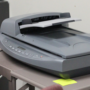 A scanner is placed on a small table. 
