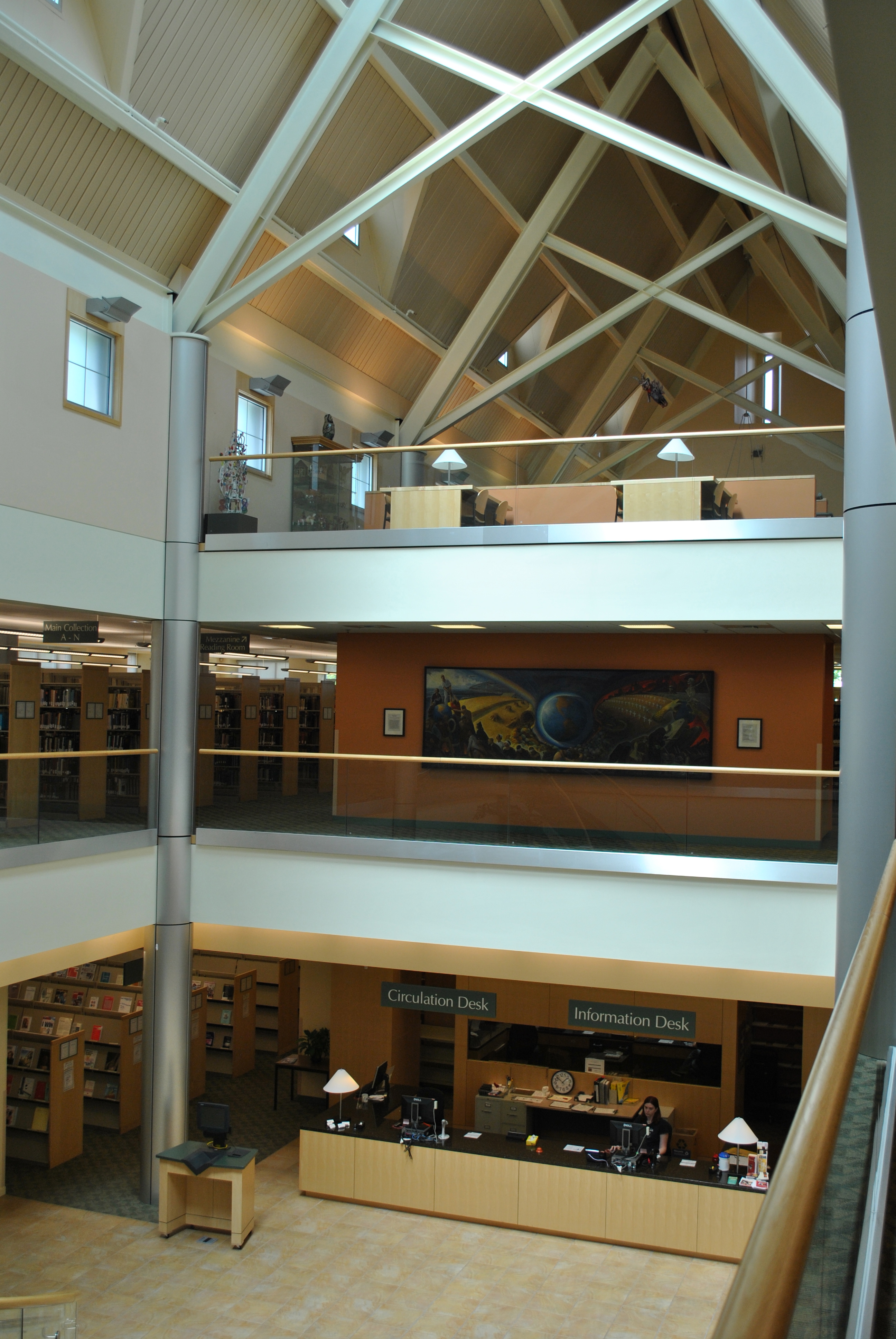 This image shows a large open area inside a building. There are three floors visible along with a valted ceiling.