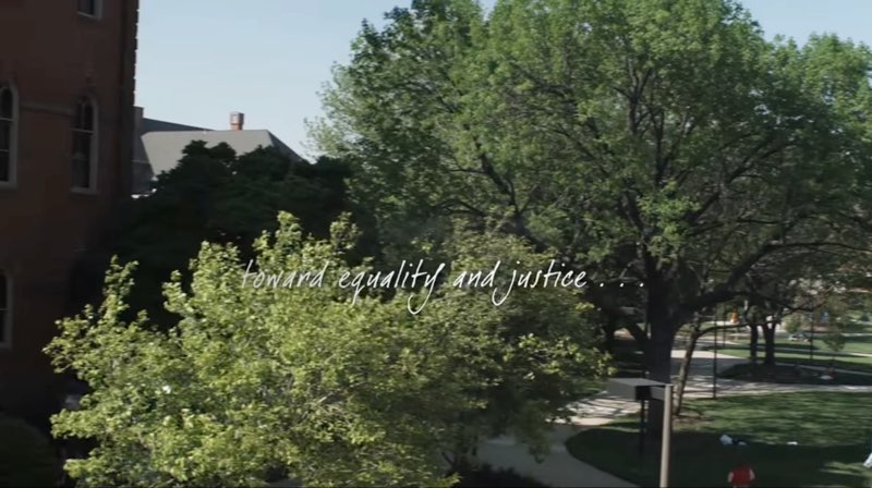 An overview shot scans the Gallaudet campus in the daytime with trees, grass, and a building in the background. Words are handwritten across the screen reading, "toward equality and justice."