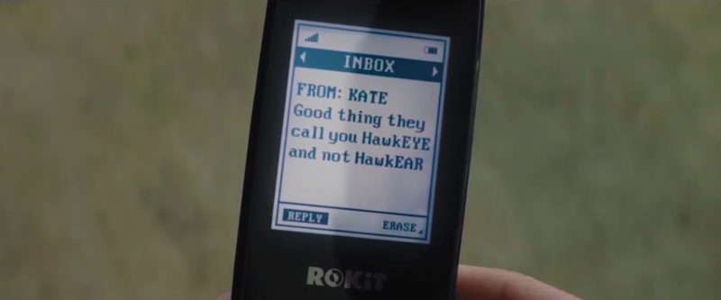 A cellphone is shown; the phone screen shows a message from Kate, "Good thing they call you HawkEYE and not HawkEAR."