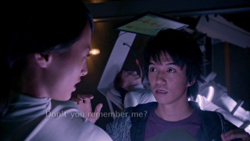 Miko is waking up and looking at Ren, who looks hopeful and sad. The words, "Don't you remember me?" are low on the screen, almost completely faded out.