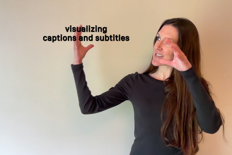 Janine Butler looks at the space next to her as she signs "visualizing." Subtitles appear next to her that read, "visualizing captions and subtitles."