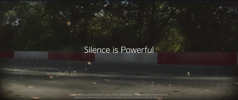Part of a racetrack is shown. Words appear in the center of the frame. The words read, "Silence is Powerful."
