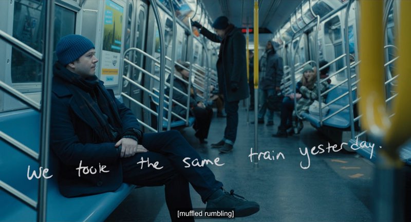 Theo is seated in a subway train. The handwritten words are shown across the screen reading, "We took the same train yesterday."