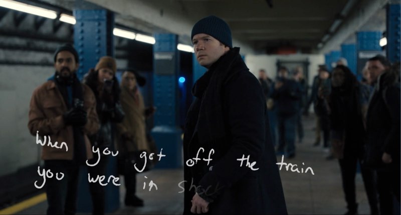 Theo is standing at a subway platform looking intently into the distance with other people behind him looking in the same direction. Handwritten words on screen read, "When you got off the train you were in shock." The phrase is incomplete and still being written on screen.