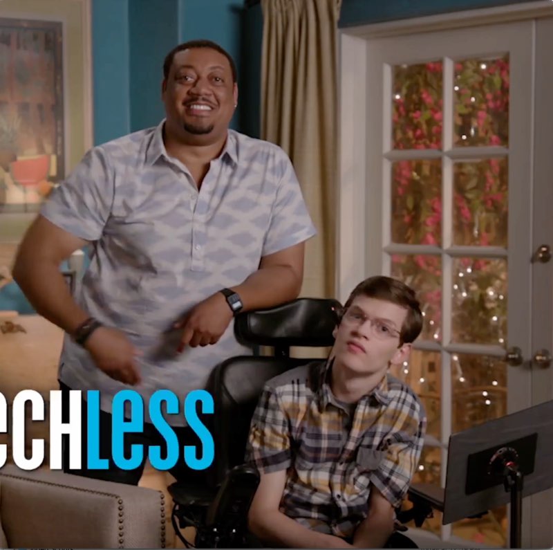 Cedric, standing next to Micah, is speaking. Cedric's arm is pushing the word “Speechless” off screen with only part of the word shown.