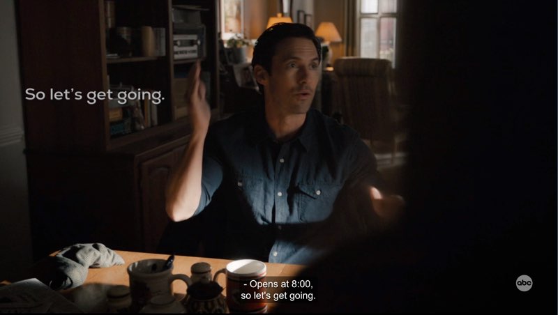 Charlie is seated at the dining table and signing, “get going.” Open subtitles appear next to him that read, "So let's get going." Closed captions at the bottom "Opens at 8:00, so let's get going."