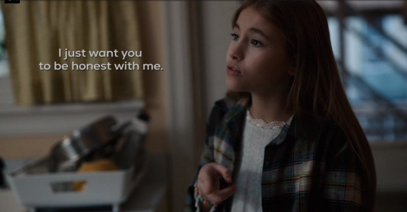 Ollie is in her kitchen signing with subtitles next to her near her face that read "I just want you to be honest with me."