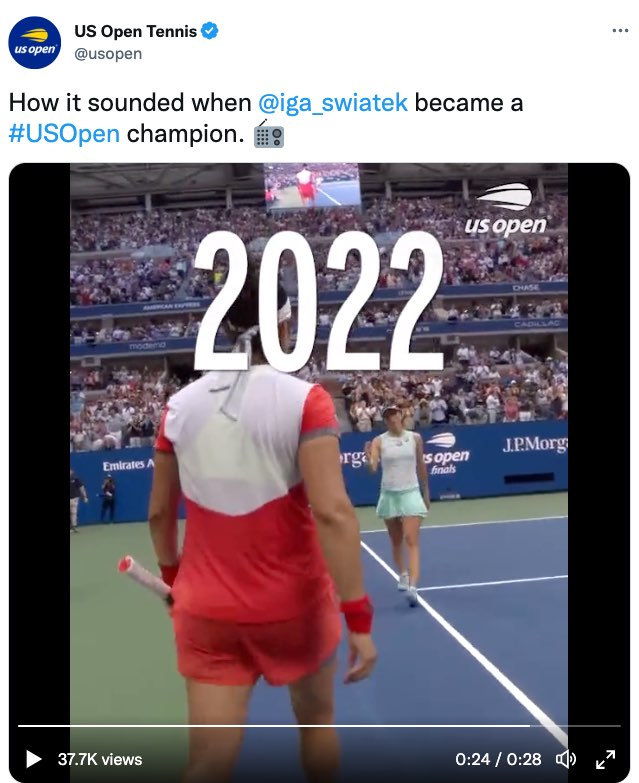 A tweet by US Open Tennis. The tweet reads, "How it sounded when @iga_swiatek became a #US Open champion." The tweet ends with an emoji of a radio. The tweet includes a video that now shows Swiatek and Jabeur walking towards each other on court. Extra large open captions read, "2022."